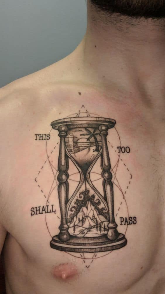 A detailed "This too shall pass" tattoo featuring an hourglass, symbolizing the passage of time and the transient nature of life's challenges.