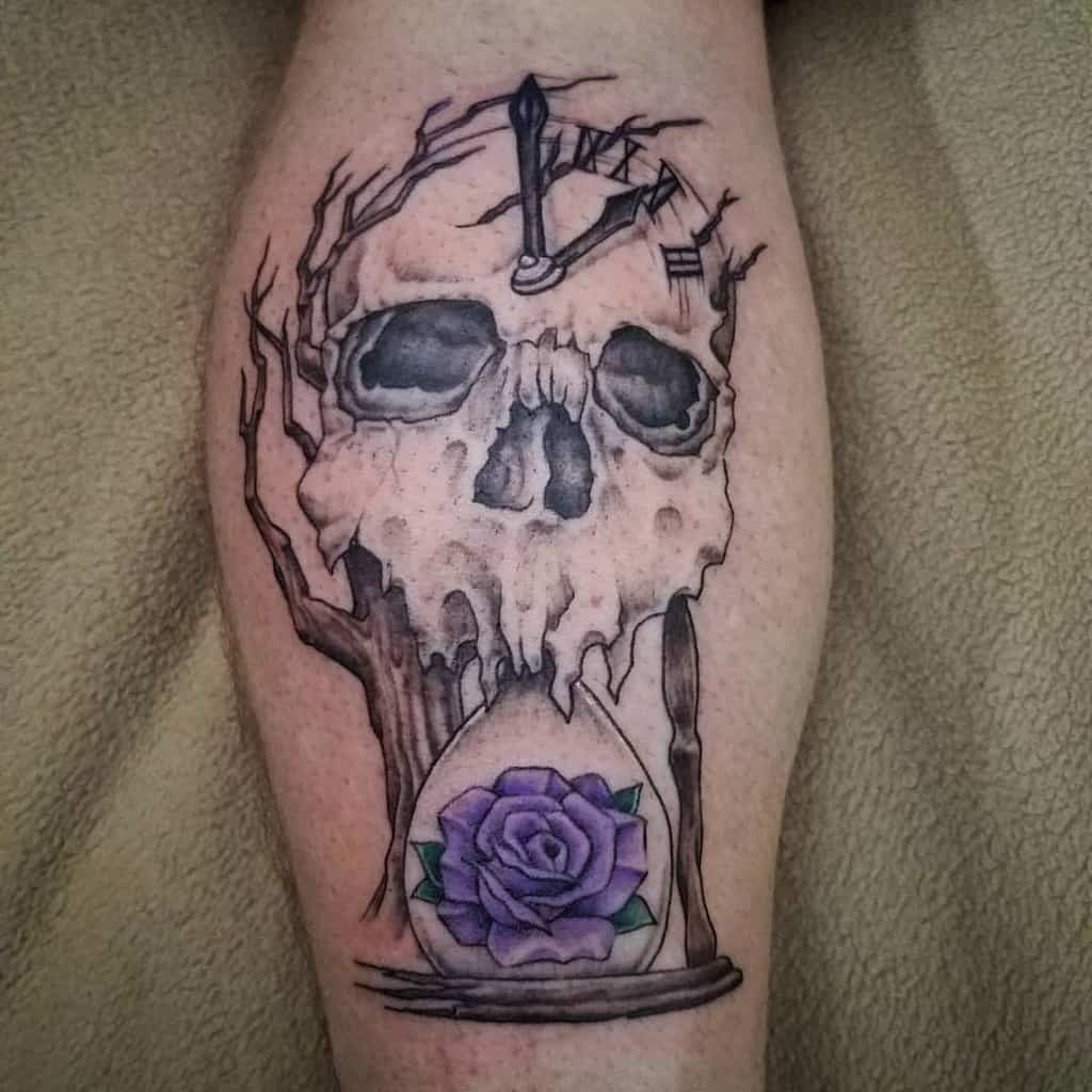 Intricate tattoo of a melting skull with tree branches, a broken clock, and an hourglass containing a purple rose, symbolizing time and mortality.