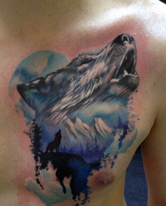 Chest tattoo featuring a howling wolf with a scenic watercolor background of mountains, moonlight, trees, and two wolf silhouettes.