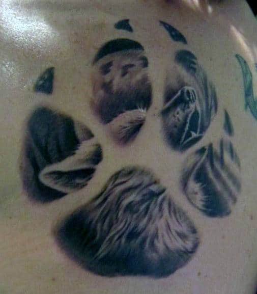 Howling Wolf With Moon Inside Paw Male Chest Tattoo Design Ideas