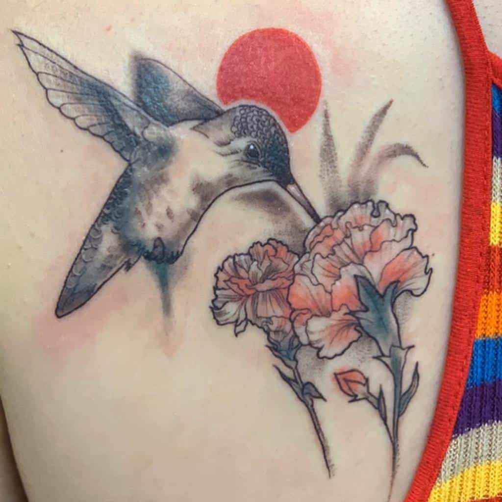 Tattoo of a hummingbird near carnation with leaves with a red sun in the background