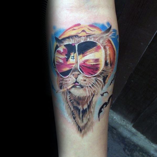Creative Hunter S. Thompson-inspired tattoo featuring a cat wearing aviator glasses reflecting a desert scene, with bats flying in the background.