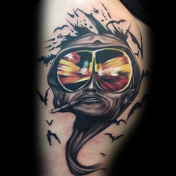 Surreal Hunter S. Thompson tattoo featuring melting facial features, aviator glasses reflecting a desert scene, bats flying, and a cigarette.