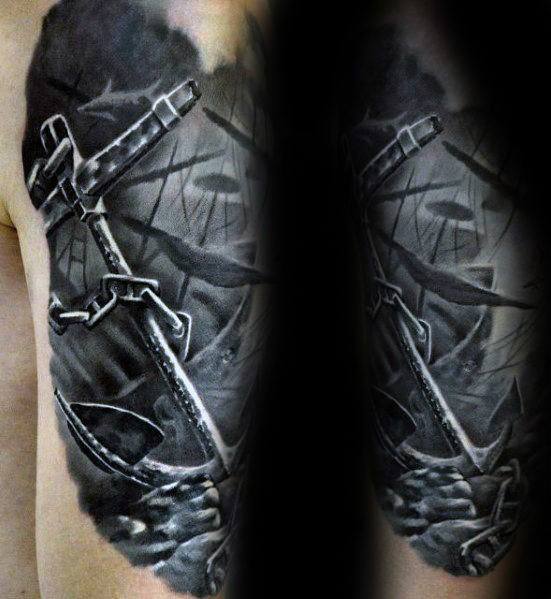 Dark black and grey tattoo of a large anchor in front of a shipwreck scene with broken masts, deep shadows, and dramatic ocean tones.