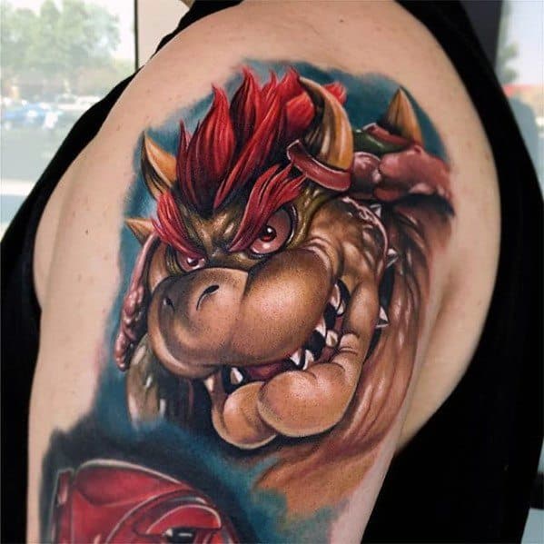 Realistic Bowser tattoo on a man's shoulder with intense shading, rich colors, and fierce expression, creating a bold and detailed Mario-inspired design.