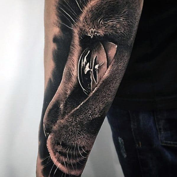 Hyper-realistic cat tattoo on the forearm, featuring detailed fur and a reflective eye for a striking and lifelike design.