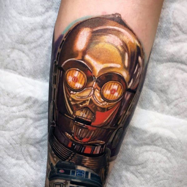 Hyper-realistic C-3PO tattoo with reflective gold detailing and intricate shading, creating a strikingly lifelike metallic effect.