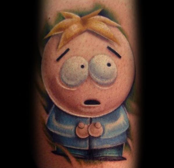 Realistic South Park tattoo of Butters with a worried expression, featuring soft shading, vibrant colors, and a detailed background.