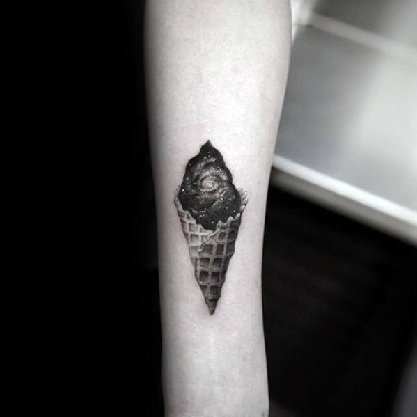 Black and grey tattoo of an ice cream cone with a swirling galaxy scoop, blending realism and cosmic surrealism with fine shading and intricate details.