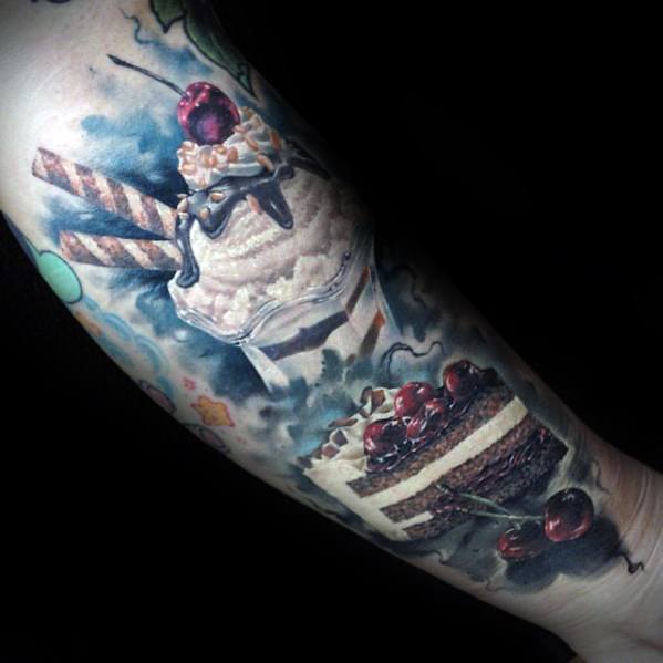 Hyper-realistic tattoo of a whipped cream-topped milkshake with chocolate drizzle, wafer sticks, and a cherry, alongside a detailed cherry cake slice.