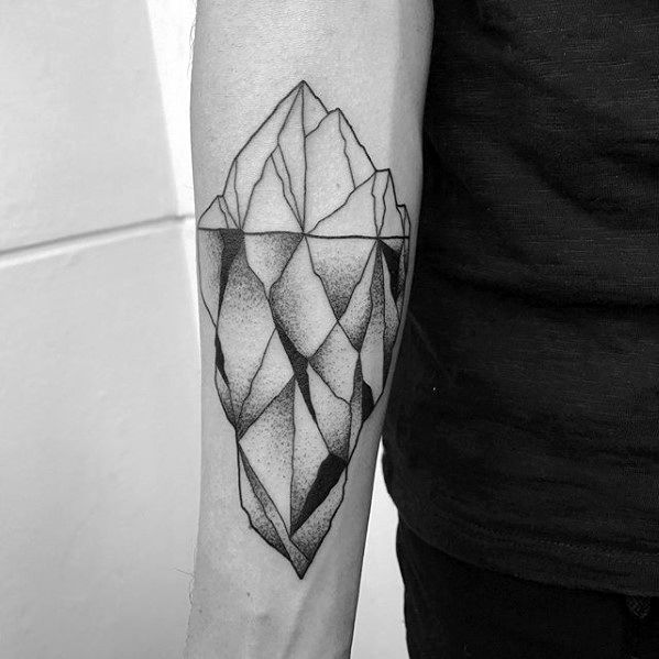Large forearm iceberg tattoo with sharp geometric outlines and dotwork shading, emphasizing the submerged portion below the waterline.