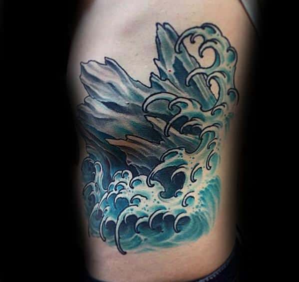 Colorful rib tattoo of crashing ocean waves against sharp icebergs, blending traditional Japanese wave style with icy realism.
