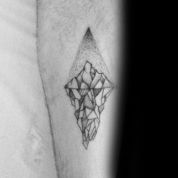 Geometric iceberg tattoo with fine lines and shaded triangular background, blending abstract structure with soft dotwork effect.