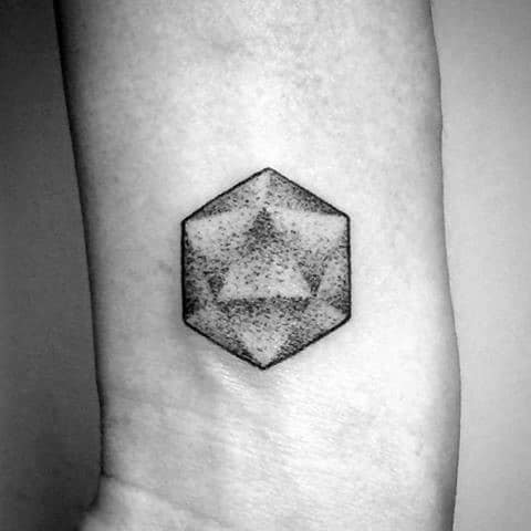 Small dotwork icosahedron tattoo on the wrist, featuring subtle shading and a soft geometric appearance.