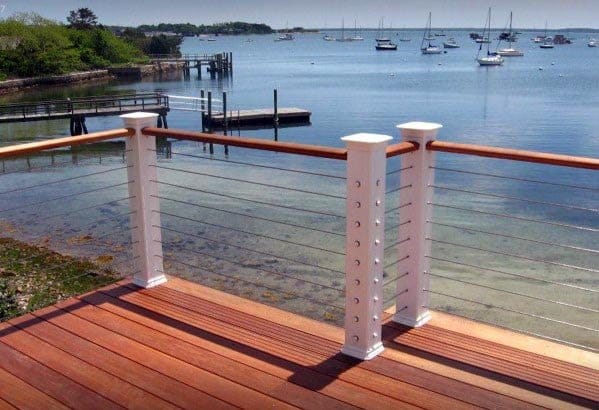 wood deck white posts cable railing water