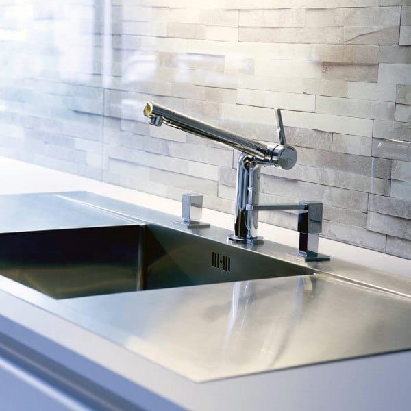 Sleek kitchen sink design featuring a modern chrome faucet and textured metallic backsplash tiles.