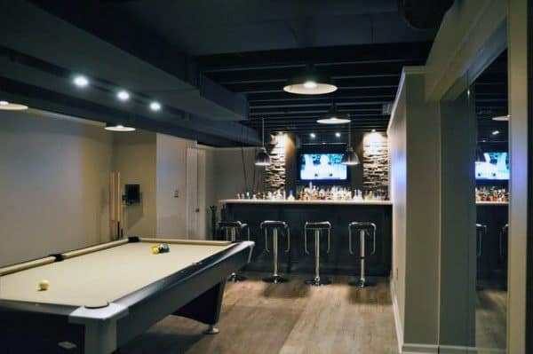 Basement with black exposed ceiling, pool table, stone-accented bar, and recessed lighting.