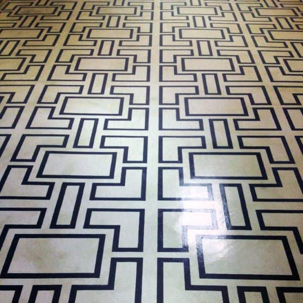 Concrete floor with a geometric black and white pattern of interconnected rectangular shapes