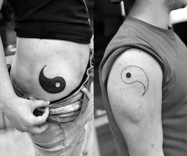 Matching yin-yang tattoos on the waist and upper arm, symbolizing harmony, balance, and two souls that complete each other.