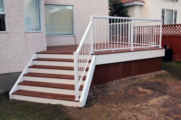 small backyard deck with stairs white railing wood skirting
