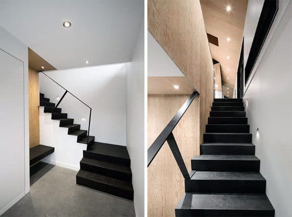 Modern black staircase with minimalist glass railing and wood accents in a bright hallway.