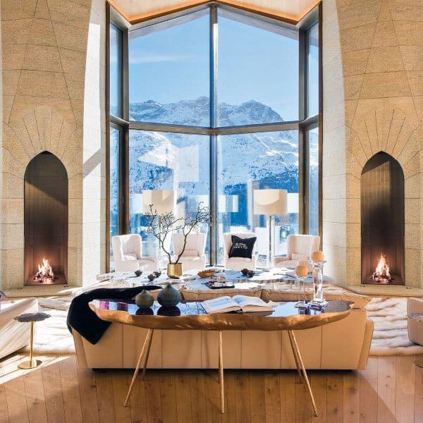 stylish luxury living room with dual fireplaces and floor to ceiling windows