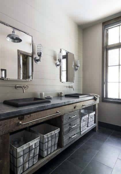 Rustic bathroom with dual sinks, mirrors, and baskets under a window