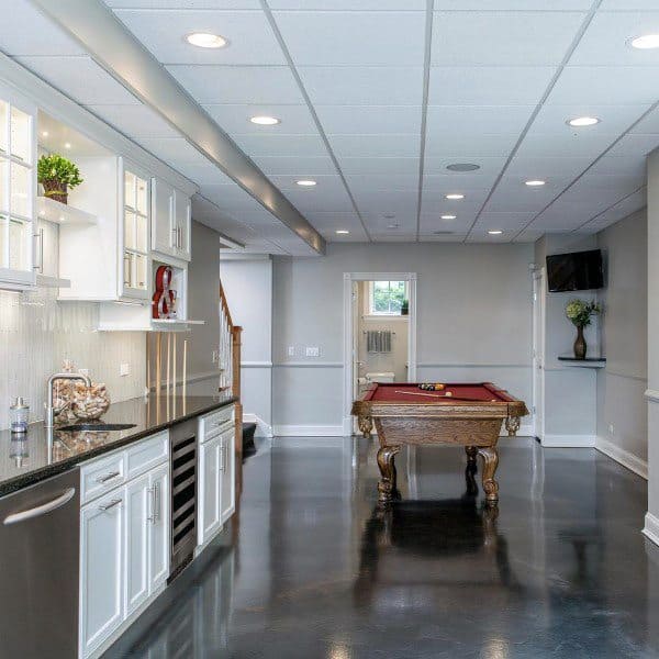 Bright basement with white drop ceiling, recessed lighting, kitchenette, and pool table.