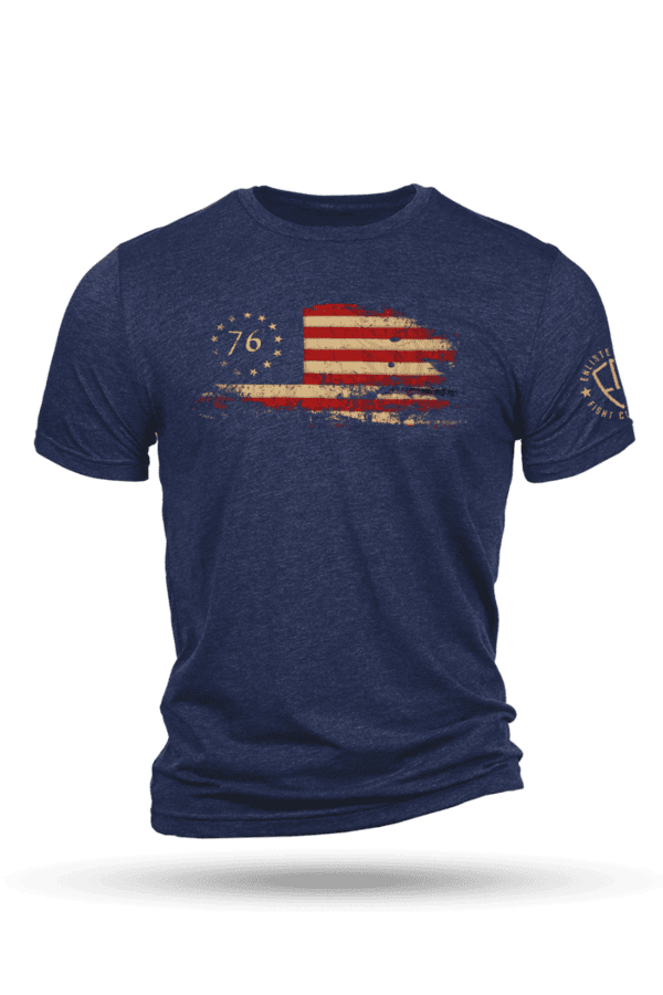Navy blue patriotic shirt featuring a distressed Betsy Ross flag, "76" on the chest and a circular emblem on the left sleeve