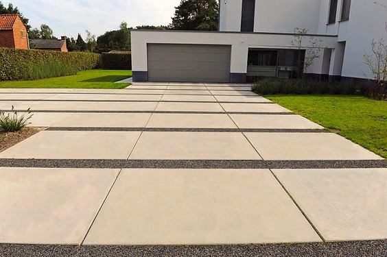 concrete paver driveway with landscaping pebbles