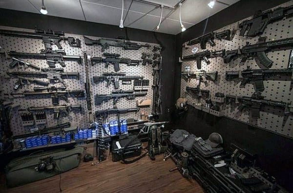 Gun room with pegboard walls displaying firearms, accessories, and neatly organized gear.