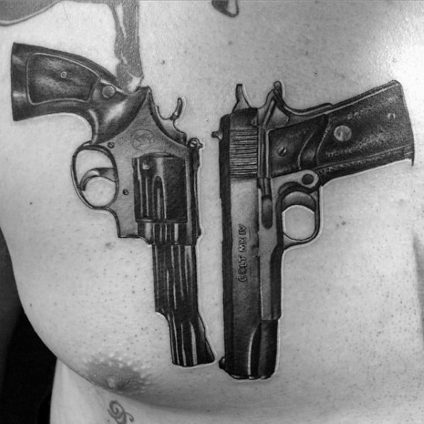 Realistic black and gray chest tattoo featuring a Colt 1911 pistol and a revolver, designed with detailed shading for a bold and lifelike effect.