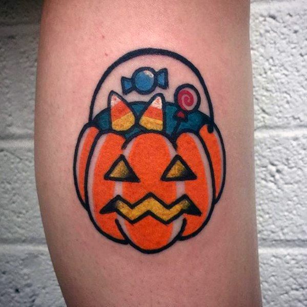 Minimalist Halloween tattoo of a pumpkin-shaped candy bucket filled with sweets, featuring bold outlines and a playful, cartoon-style design.