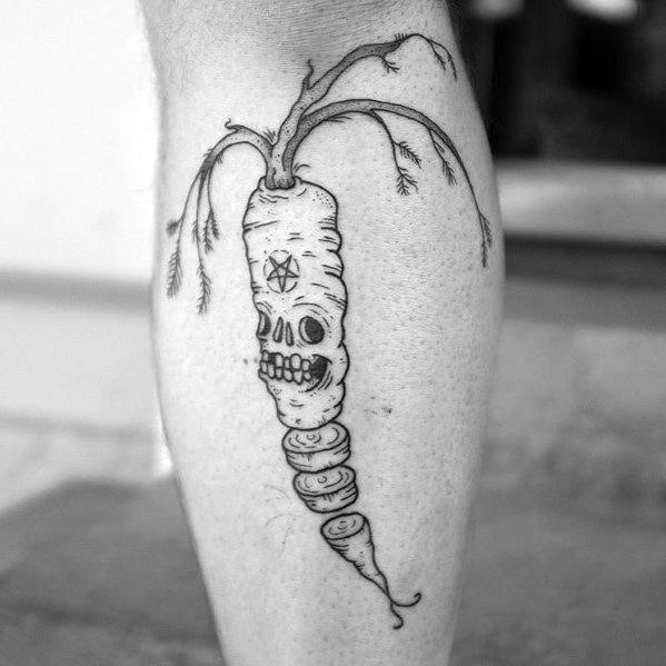 Dark-themed black ink carrot tattoo featuring a skull-like design, twisted root details, and eerie wilted leaves for a bold and gothic look.