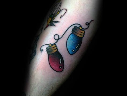 Christmas tattoo of two red and blue holiday light bulbs connected by a wire, featuring soft shading and a simple, festive design.