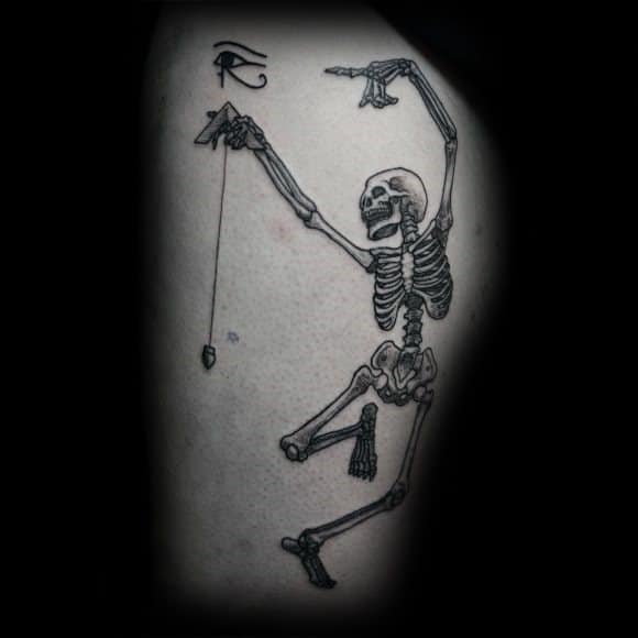 Dancing skeleton tattoo with a playful pose, holding a pendulum and featuring the Eye of Horus, blending mystical and energetic elements.