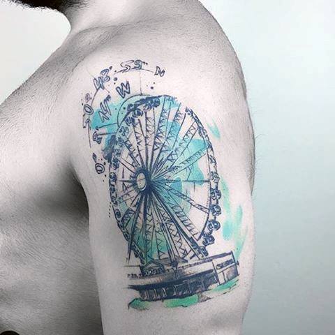 Sketch-style Ferris wheel tattoo with blue watercolor accents, compass elements, and fine line details, creating a dynamic and artistic design.