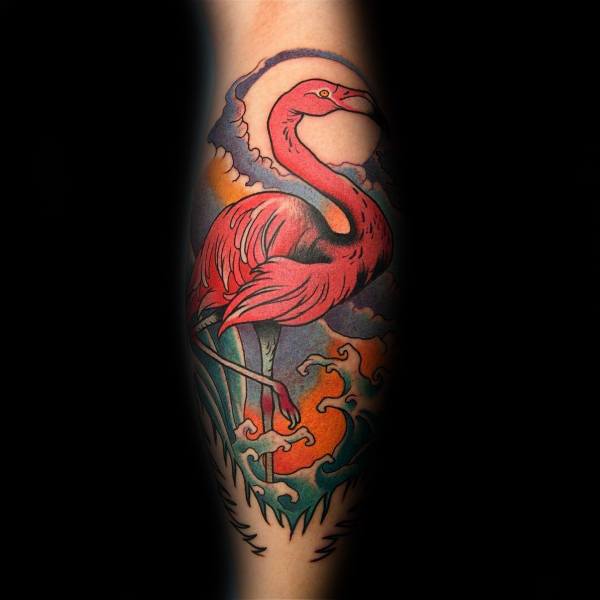 Neo-traditional flamingo tattoo with bold red hues, dynamic waves, and a dramatic sunset background, creating a striking and artistic design.