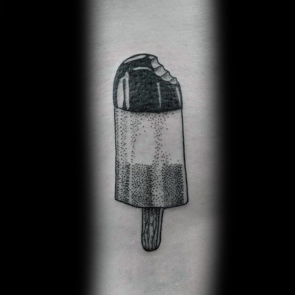Black and grey tattoo of a bitten popsicle, featuring fine dot work shading and smooth gradients for a realistic yet minimalist design.