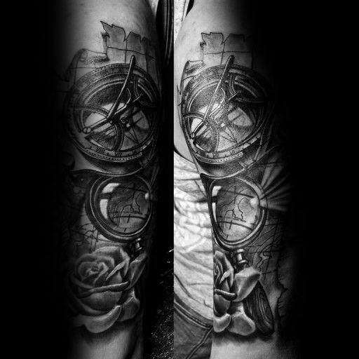 Tattoo featuring a magnifying glass, compass, world map, and roses, designed with deep shading for a bold and adventurous black-and-gray look.