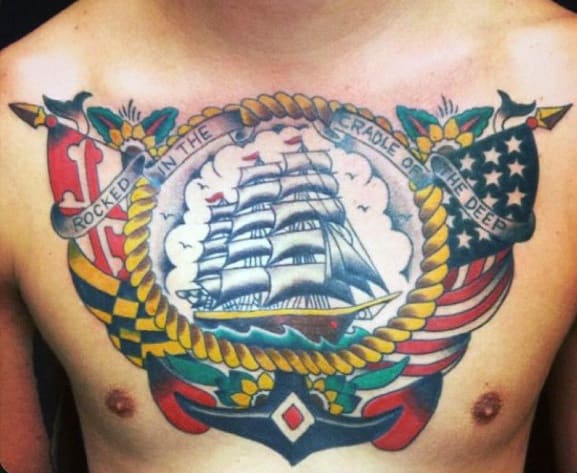 Nautical-themed chest tattoo featuring a sailing ship framed by a rope, with Maryland and American flag elements and a "Rocked in the Cradle of the Deep" banner.