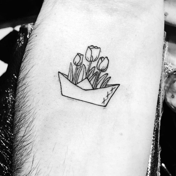 Minimalist paper boat tattoo with tulips, symbolizing growth, hope, and the beauty of new beginnings.