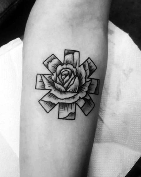 Forearm tattoo featuring the Red Hot Chili Peppers logo with a detailed black and grey rose in the center, creating a bold yet elegant design.
