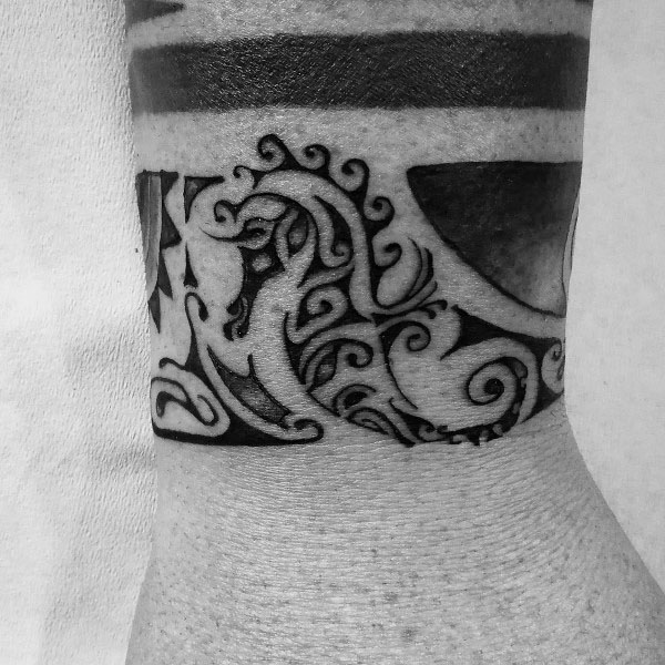 Polynesian-style seahorse tattoo on wrist, featuring bold black ink with intricate tribal patterns and swirling details for a striking look.