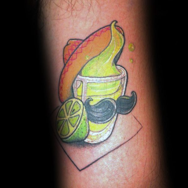 Playful shot glass tattoo featuring a lime drink, sombrero, mustache, and lime wedge, creating a fun and festive Mexican-inspired design.