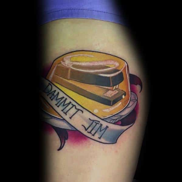 Color tattoo of a stapler encased in Jell-O with a banner reading "Dammit Jim," referencing Dwight’s reaction to Jim’s classic prank from The Office.