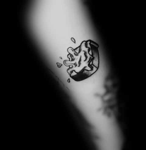 Small black ink toast tattoo with melting butter, drawn in a sketch-like style with bold outlines and minimal shading for a simple, artistic look.