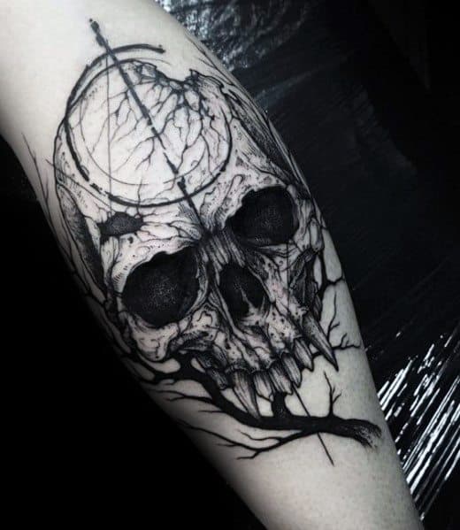 Black ink skull tattoo on the leg, featuring cracked textures, tree roots intertwining with the design, and a dark, gothic aesthetic.