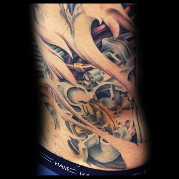 Hyper-realistic biomechanical tattoo on the side torso with a ripped skin effect, revealing detailed engine components, symbolizing a fusion of man and machine.