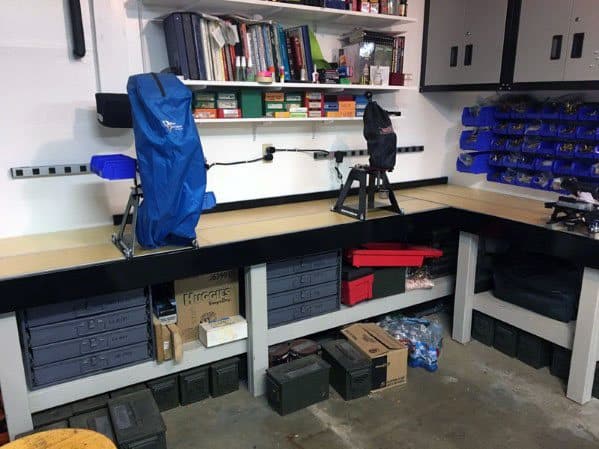 Spacious L-shaped reloading bench with mounted presses, organized shelves, and ample storage for tools and ammo supplies